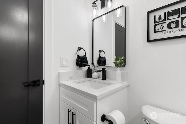 bathroom featuring vanity and toilet