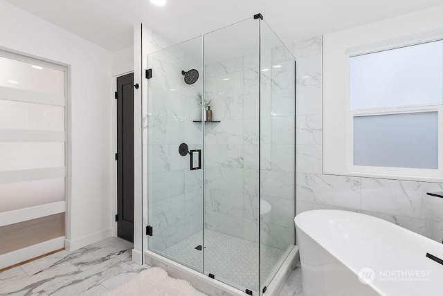 bathroom featuring independent shower and bath and tile walls