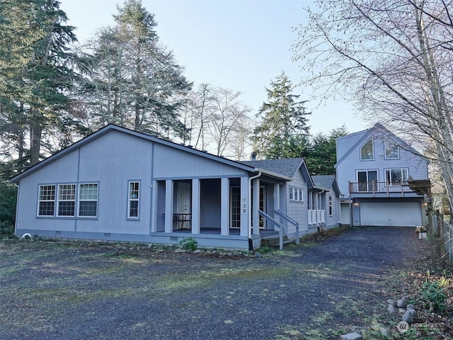 view of front of property featuring covered porch and a garage