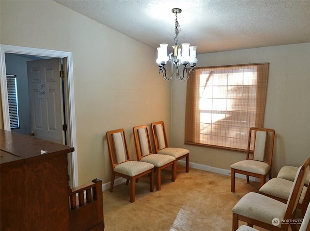 sitting room featuring light colored carpet, a textured ceiling, and a notable chandelier