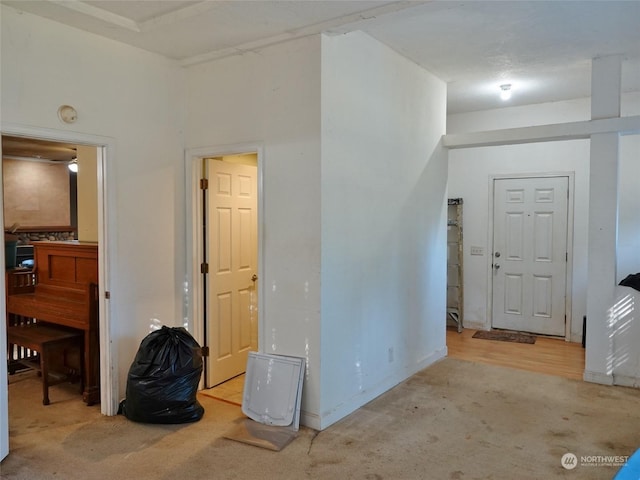 hall featuring light colored carpet