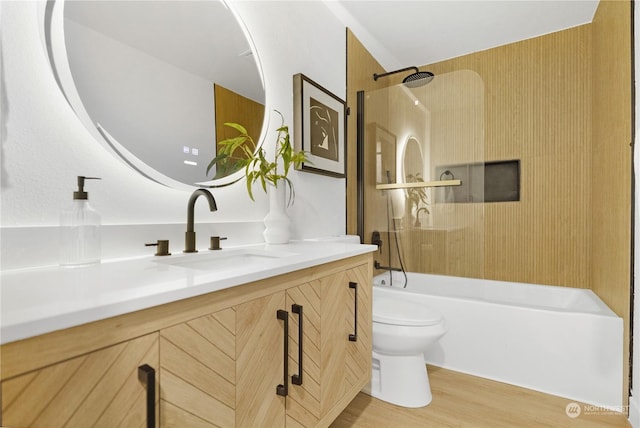 full bathroom with vanity, bathing tub / shower combination, toilet, and hardwood / wood-style flooring