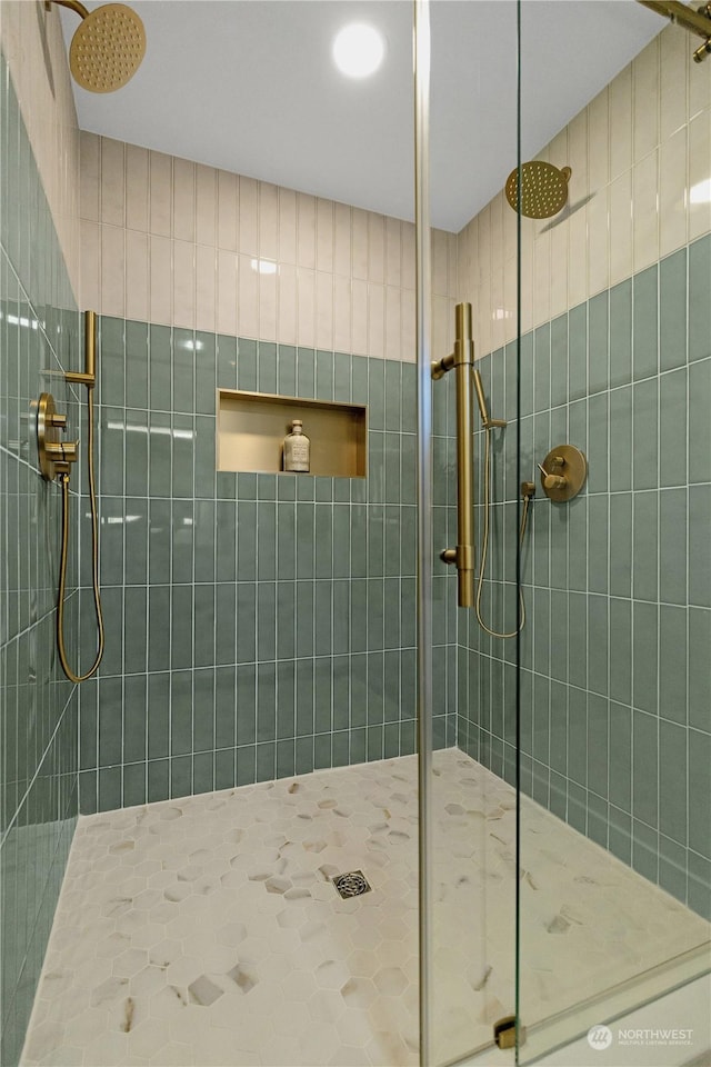 bathroom with tiled shower