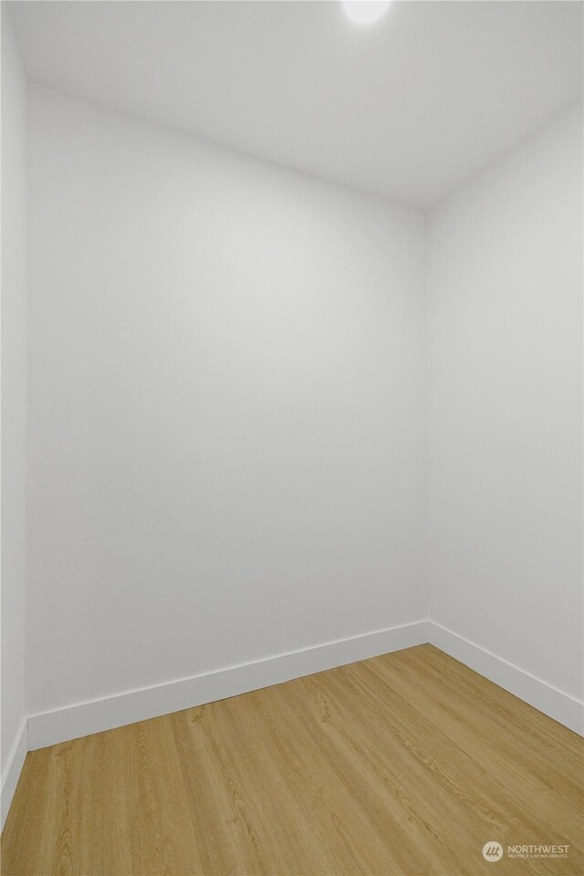 unfurnished room with hardwood / wood-style flooring