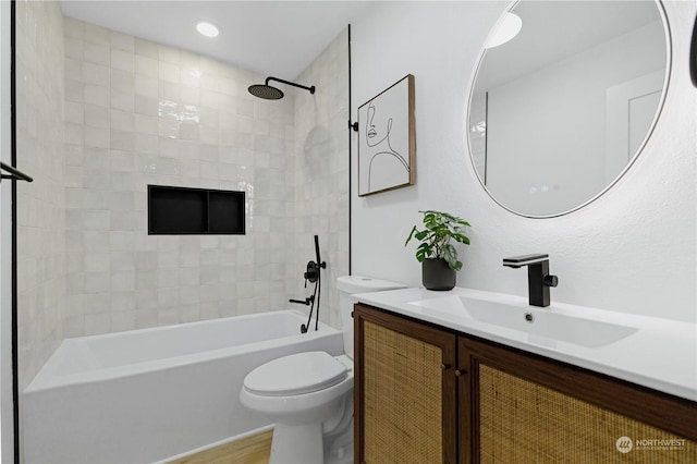 full bathroom with tiled shower / bath combo, toilet, wood-type flooring, and vanity