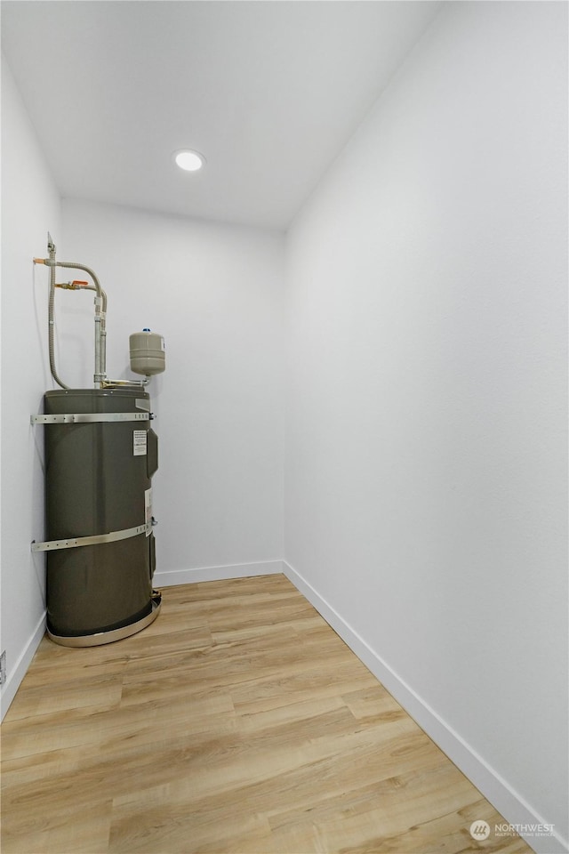 utility room with strapped water heater