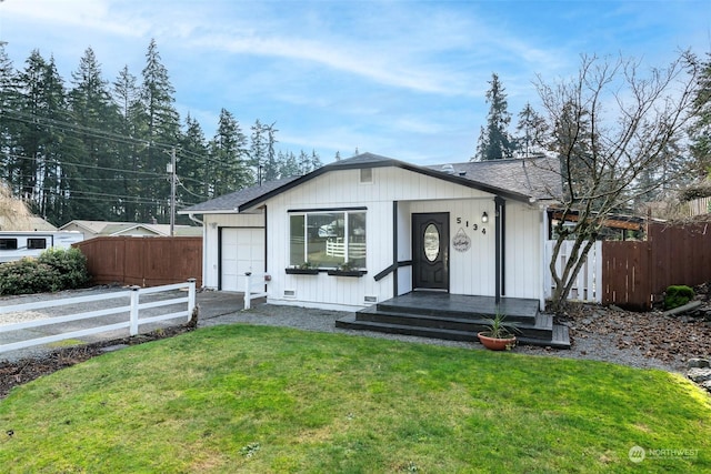 view of front of home featuring a garage and a front lawn