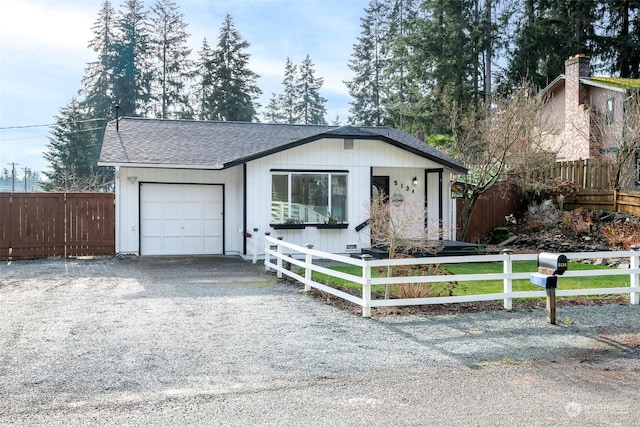 ranch-style house featuring a front yard and a garage