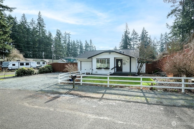 view of front of home with a front lawn and a garage