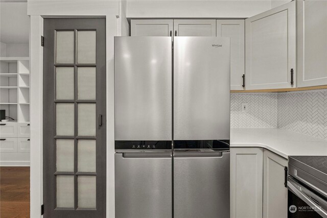 kitchen with stainless steel appliances, tasteful backsplash, and hardwood / wood-style floors