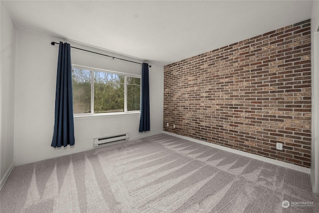 spare room with brick wall, a baseboard heating unit, and carpet