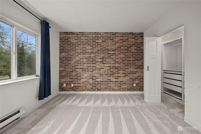 unfurnished bedroom with brick wall, multiple windows, light carpet, and baseboard heating