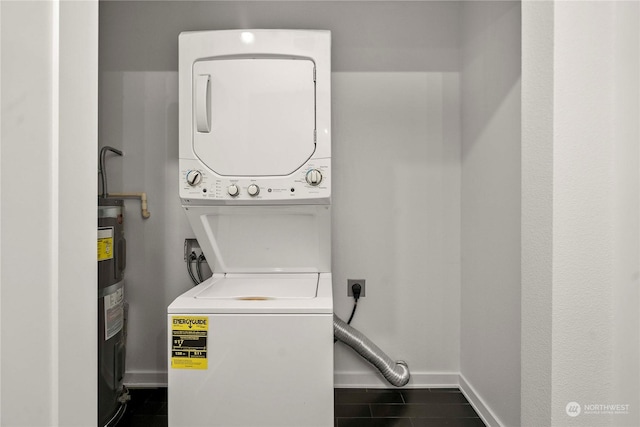 washroom featuring stacked washing maching and dryer and electric water heater