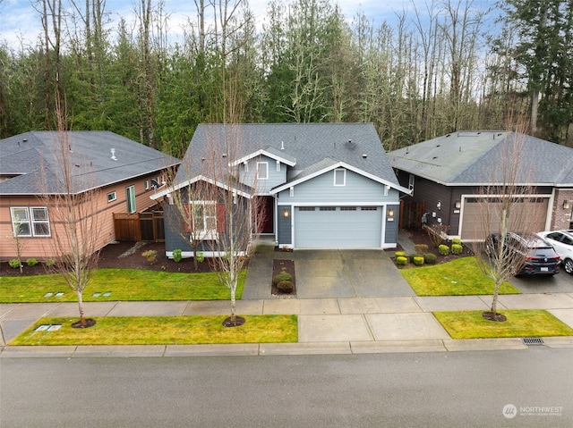 view of front of property with a front yard and a garage