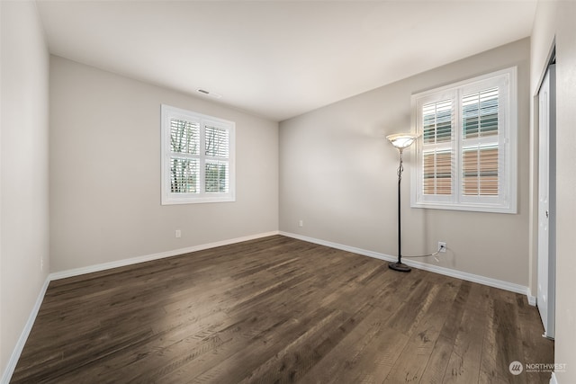 unfurnished room featuring dark hardwood / wood-style flooring