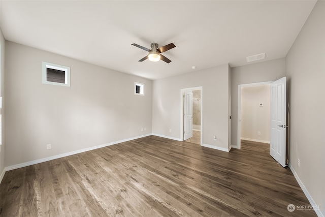 unfurnished bedroom with ensuite bath, ceiling fan, and dark hardwood / wood-style flooring