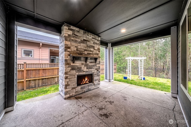 view of patio with an outdoor stone fireplace