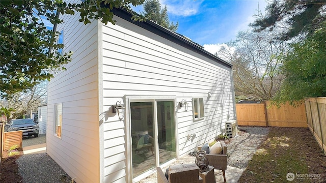 view of side of home featuring a fenced backyard