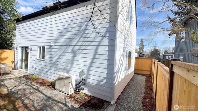 view of home's exterior with ac unit and a fenced backyard