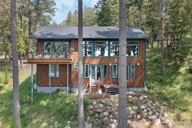 rear view of house with a hot tub