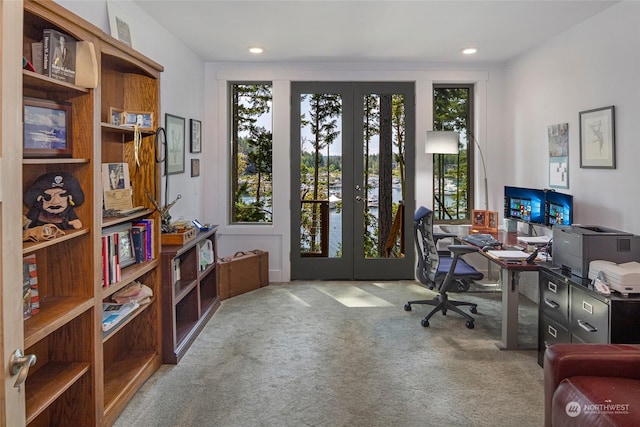 carpeted home office with french doors