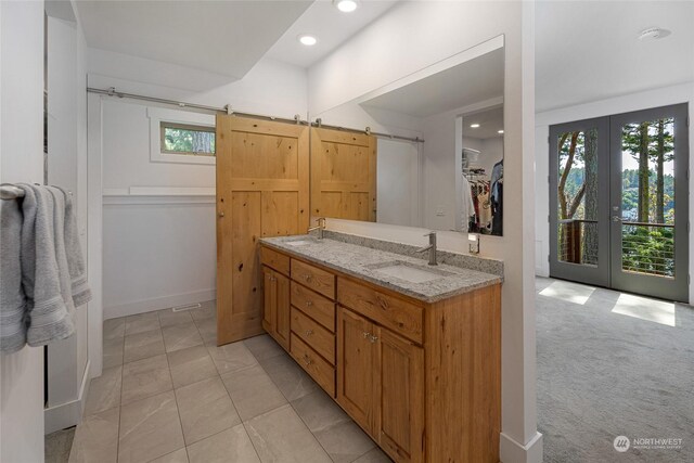 bathroom featuring french doors and vanity