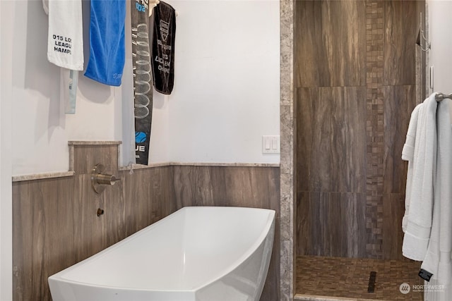 bathroom featuring separate shower and tub