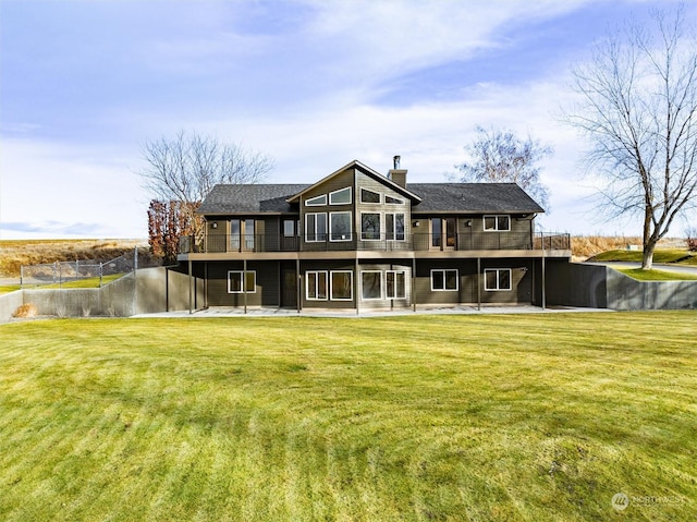 rear view of house with a yard and a patio