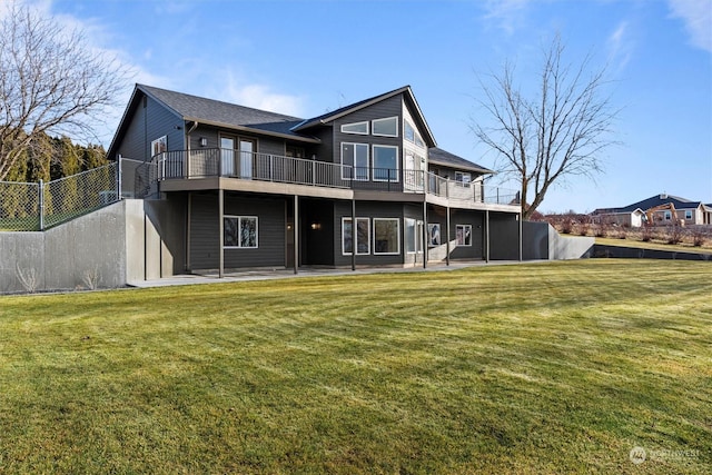 rear view of house featuring a patio area and a yard