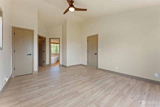 unfurnished room featuring ceiling fan, light wood-type flooring, and vaulted ceiling