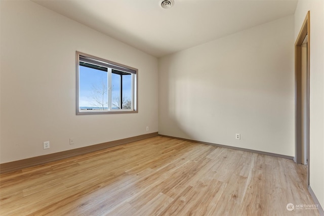 spare room featuring light hardwood / wood-style floors