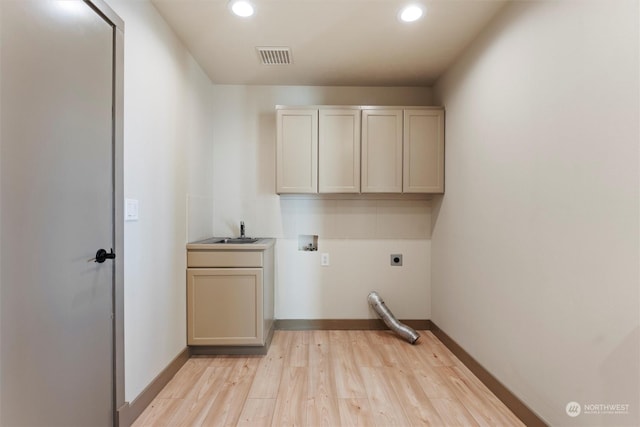 laundry room with electric dryer hookup, cabinets, sink, washer hookup, and light hardwood / wood-style floors