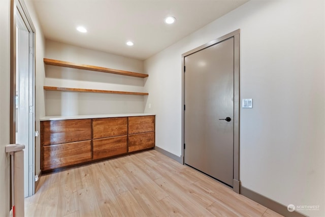 unfurnished bedroom featuring a closet and light hardwood / wood-style floors