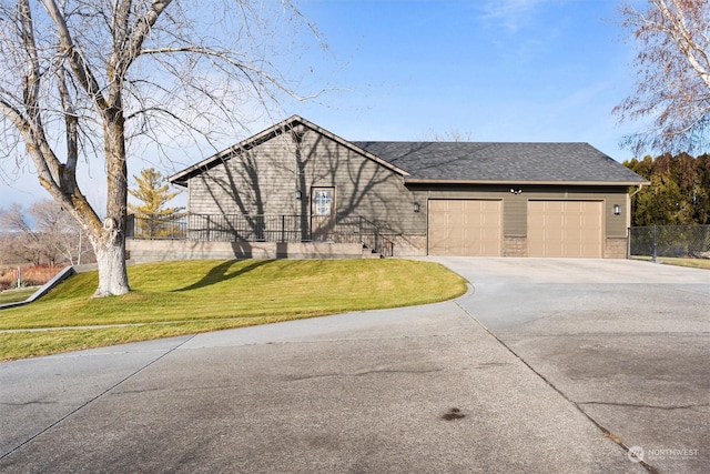 view of front of property with a front yard and a garage