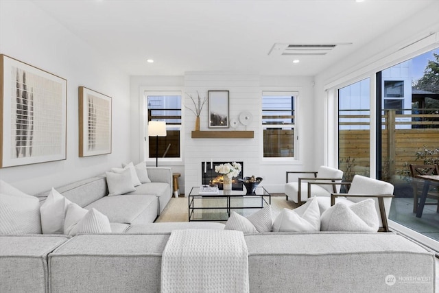 living room featuring a healthy amount of sunlight and a fireplace