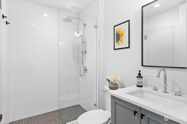 bathroom featuring an enclosed shower, vanity, and toilet