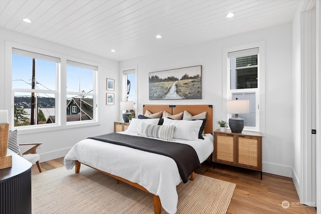 bedroom featuring wooden ceiling and light wood-type flooring