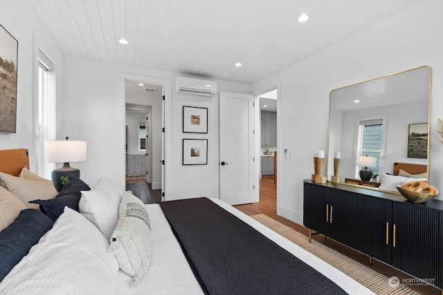 bedroom featuring hardwood / wood-style floors, wooden ceiling, and a wall unit AC