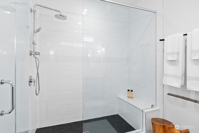 bathroom with radiator heating unit and walk in shower