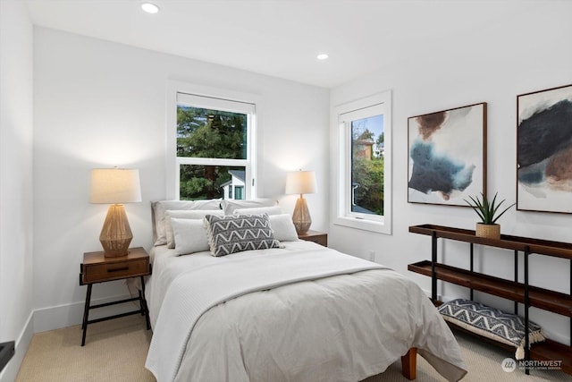 carpeted bedroom featuring multiple windows