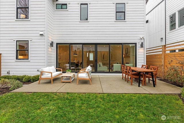 back of house with a lawn and a patio area