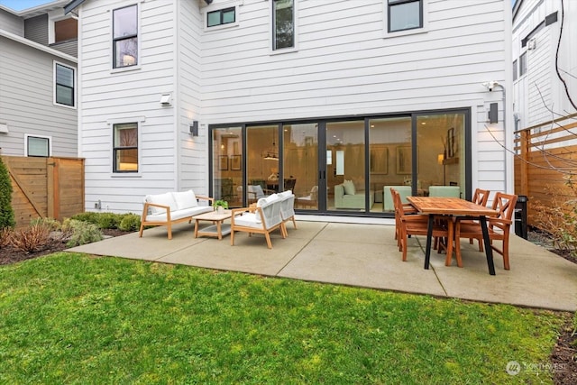 back of property featuring an outdoor hangout area, a yard, and a patio