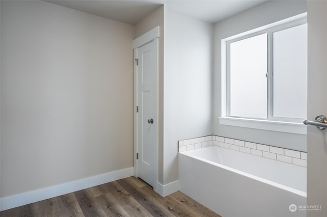 bathroom featuring hardwood / wood-style flooring and a tub