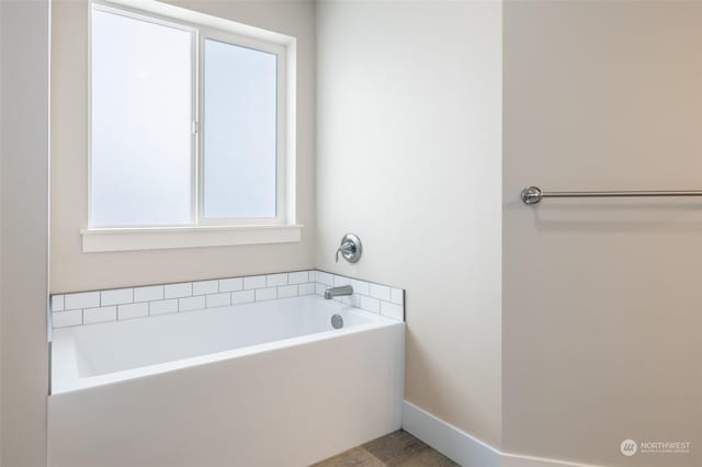 bathroom with a tub to relax in