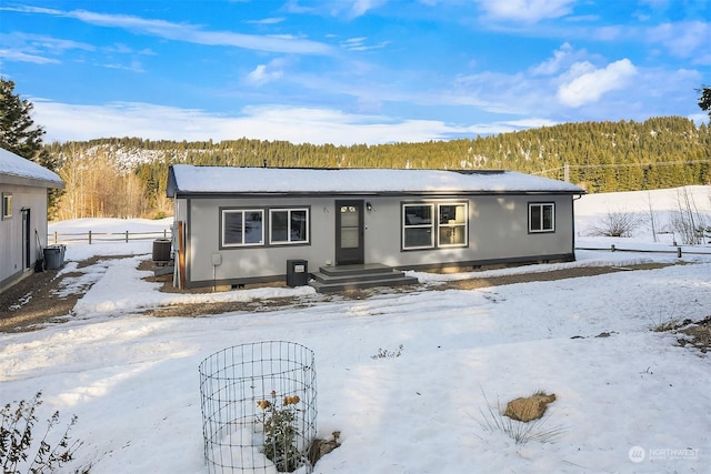 ranch-style home featuring central AC unit