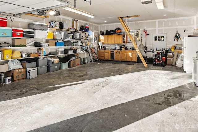 garage with white fridge and a garage door opener