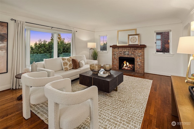 living room featuring dark hardwood / wood-style flooring and a brick fireplace