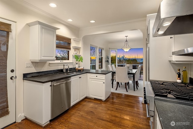 kitchen with ventilation hood, sink, white cabinetry, kitchen peninsula, and stainless steel appliances