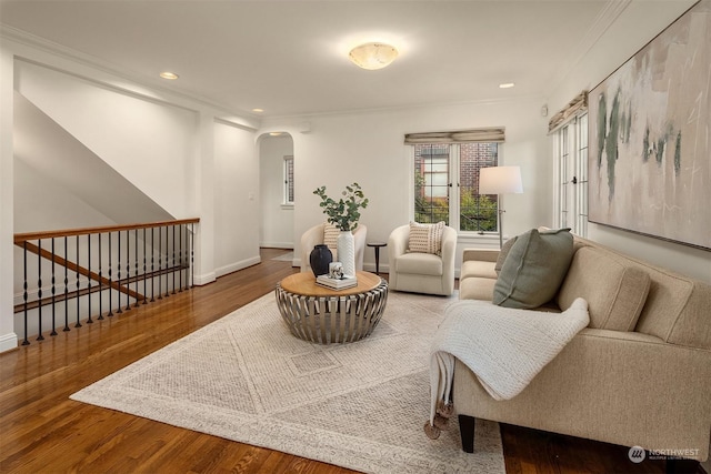 living room featuring wood-type flooring and crown molding