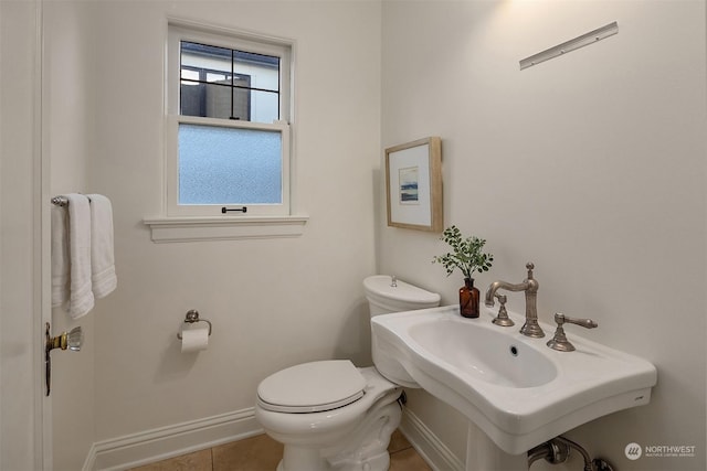 bathroom with sink, tile patterned flooring, and toilet